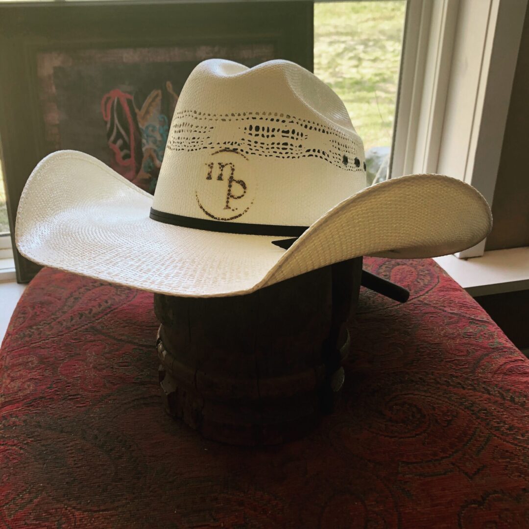 A white cowboy hat with the MP brand logo